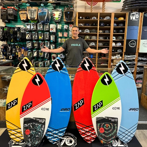 Scott showing the ZAP skimboards at the store